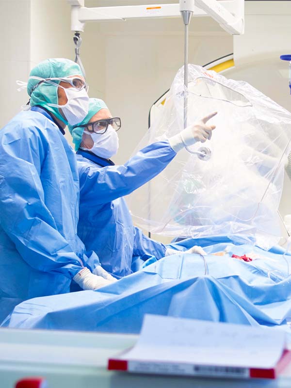 Deux chirurgiens discutent des résultats au laboratoire de cathétérisme